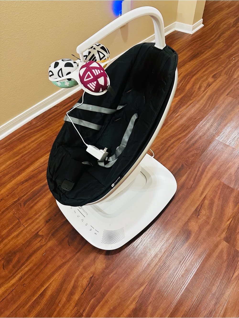 Black Infant Swing with White Base and Toy Mobile